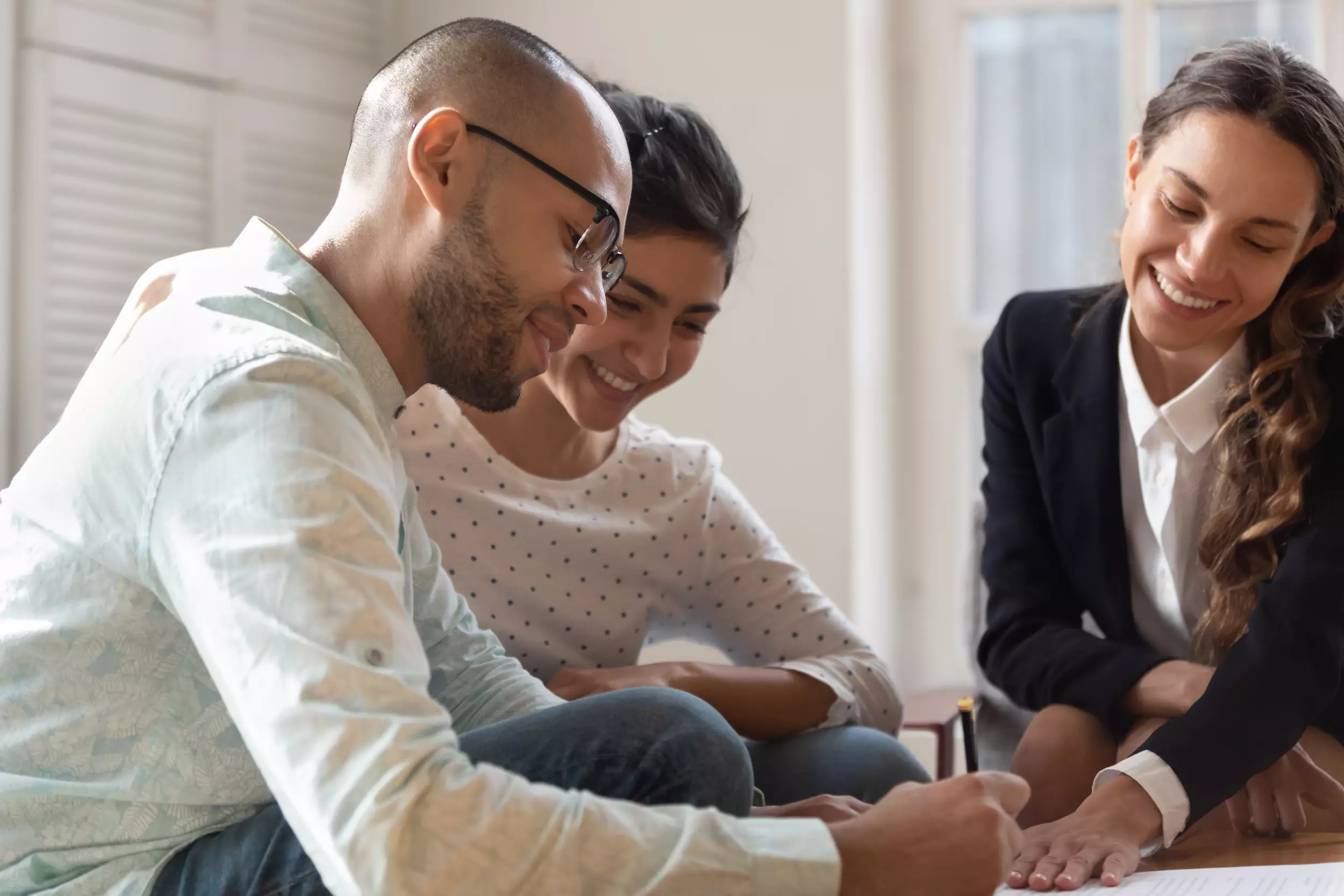 Young couple signing documents for a new home